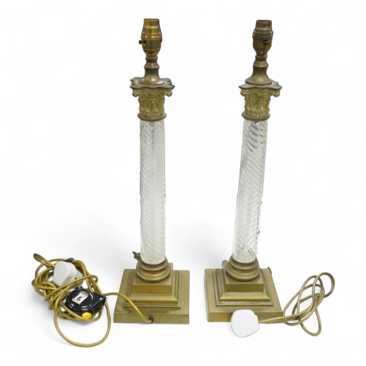 A pair of brass and glass Corinthian column lamps, 59cm high overall